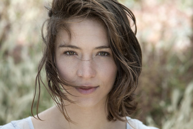 Young brunette woman alone outdoors, portrait