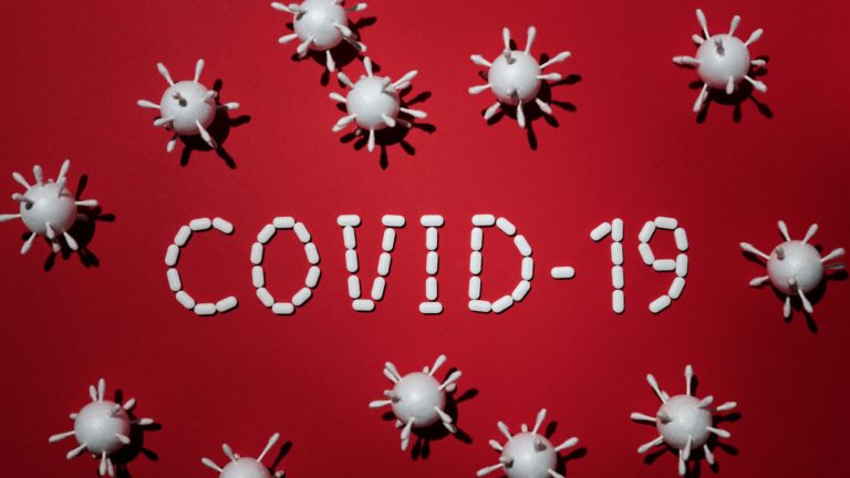 Canva – Concept Of Covid-19 In Red Background 2