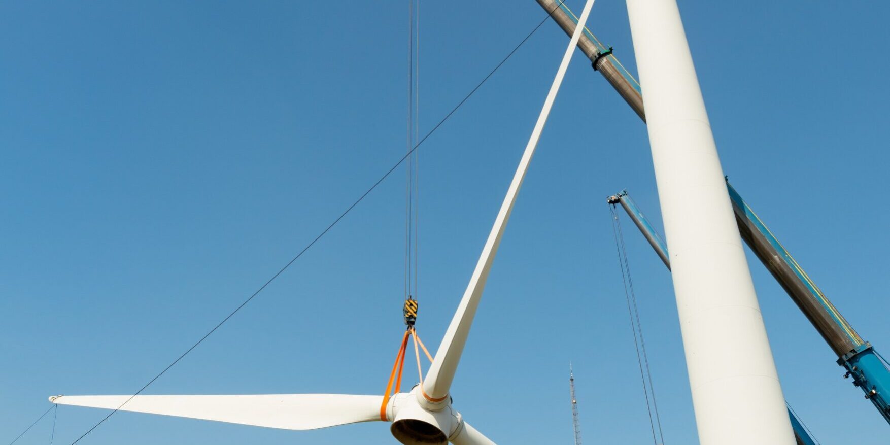 Low angle view of wind turbine being dismantled